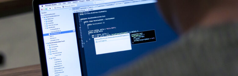 Laptop computer displaying programming code on screen