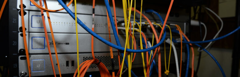 Server rack filled with colorful networking cables and equipment