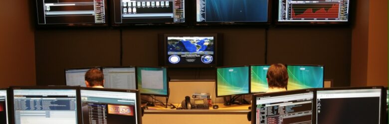 Network Operations Center with multiple monitors displaying server performance data for monitoring tutorial
