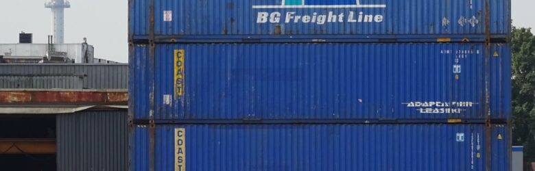 Stacked shipping containers at a port, representing containerization and orchestration in software