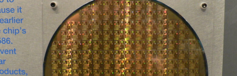 Silicon wafer with multiple microchips representing the compute costs behind AI services