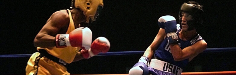 Two boxers squaring off in a boxing ring during a championship match