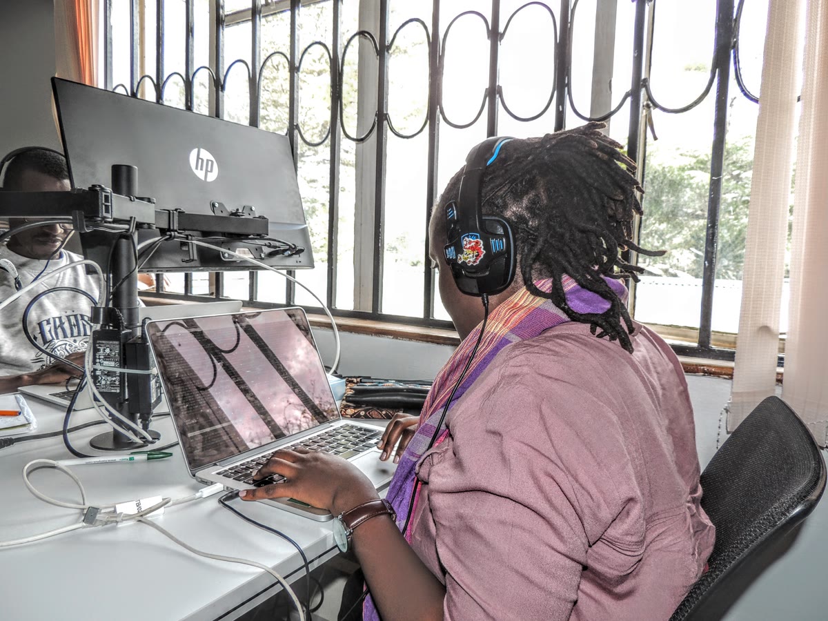 A software developer working at a desk with a laptop, representing the developer workspace where MCP servers are built