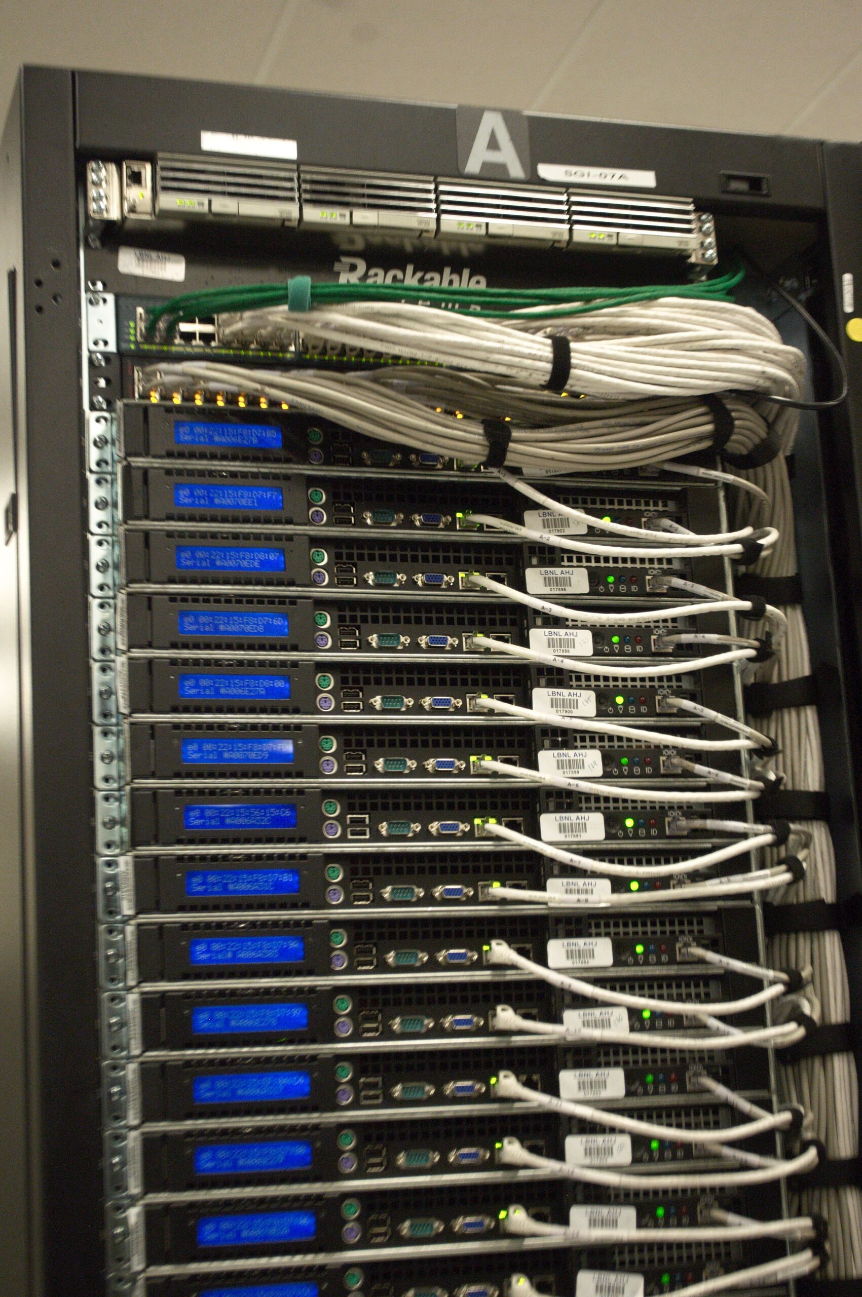 Rear of server rack with cables in a data center