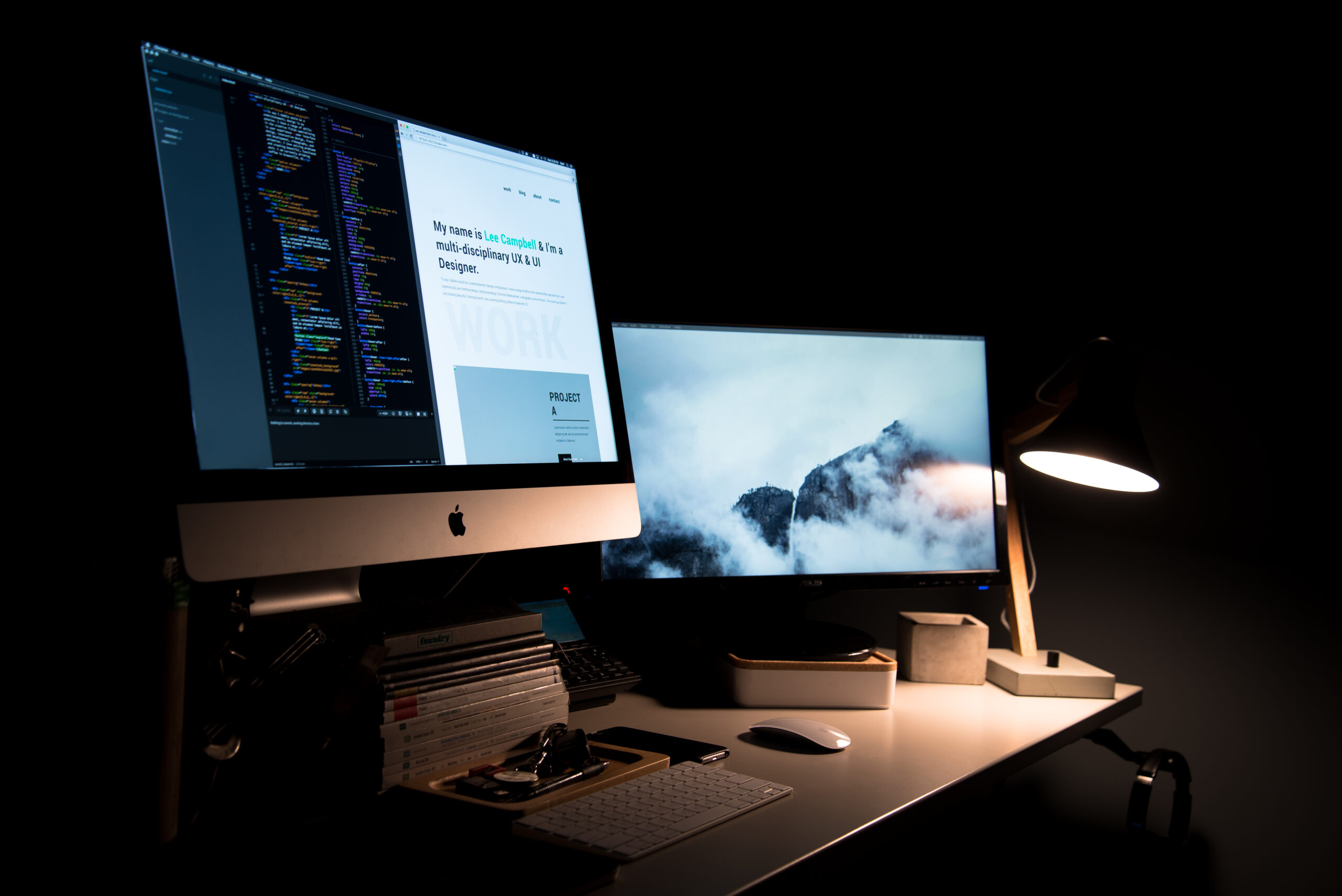 Dual monitor computer workspace setup with laptop and clean desk
