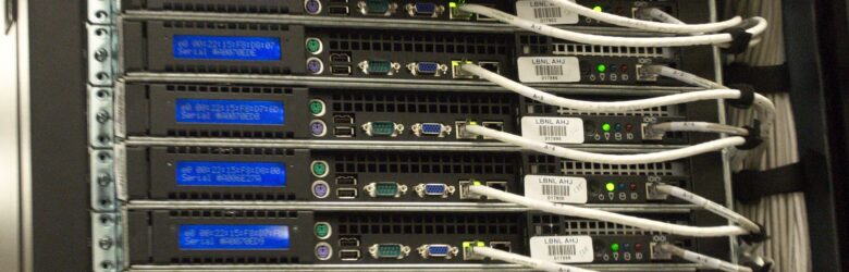 Close-up view of the rear of a server rack with colorful network cables at NERSC data center