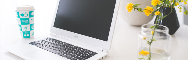 Geekbench 7 running on a laptop with a coffee cup on a desk workspace