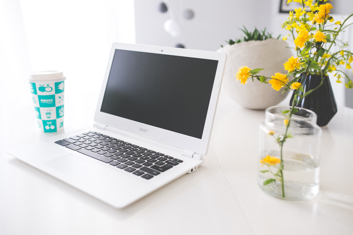 Geekbench 7 running on a laptop with a coffee cup on a desk workspace