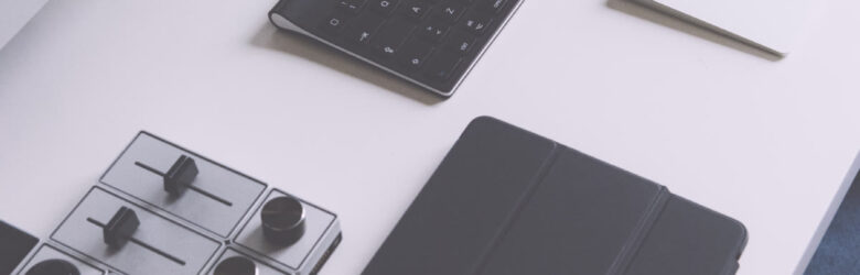 A collection of gadgets on a desk including a smartphone, smartwatch, and tablet, representing the developer workspace targeted by npm supply chain attacks