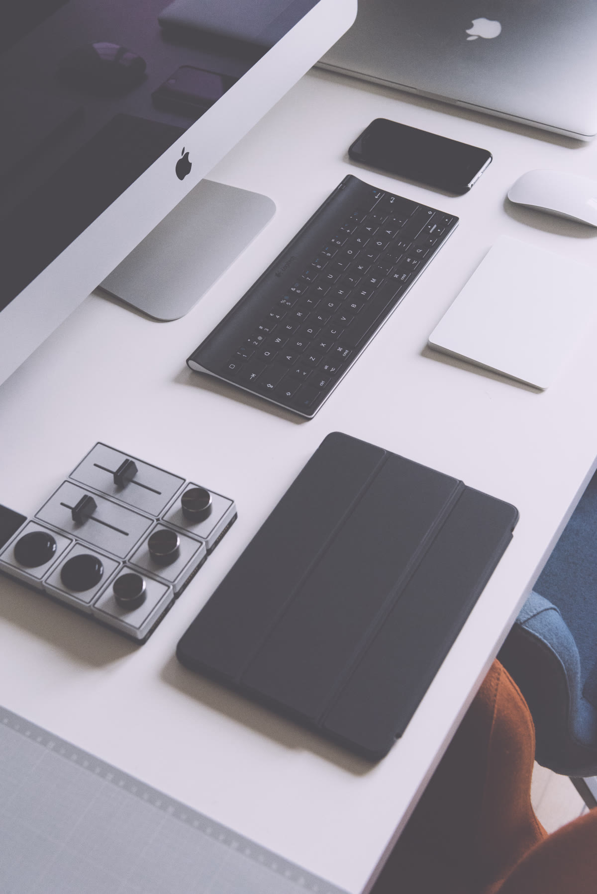 A collection of gadgets on a desk including a smartphone, smartwatch, and tablet, representing the developer workspace targeted by npm supply chain attacks