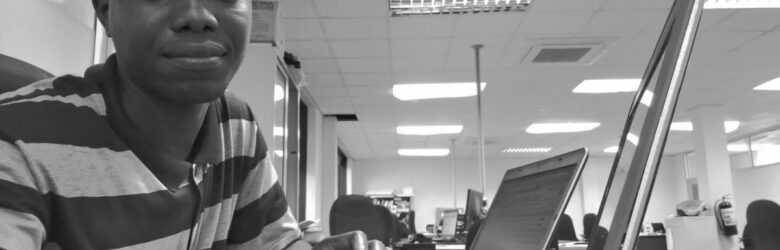 A software developer working on a computer in an office environment, representing the intersection of AI coding tools and developer privacy