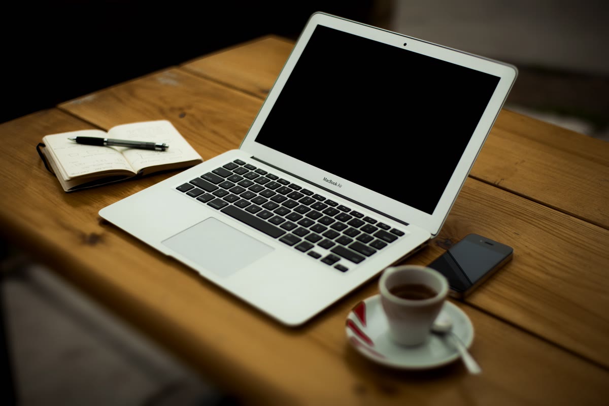 A home office desk with a laptop and books representing independent web publishing