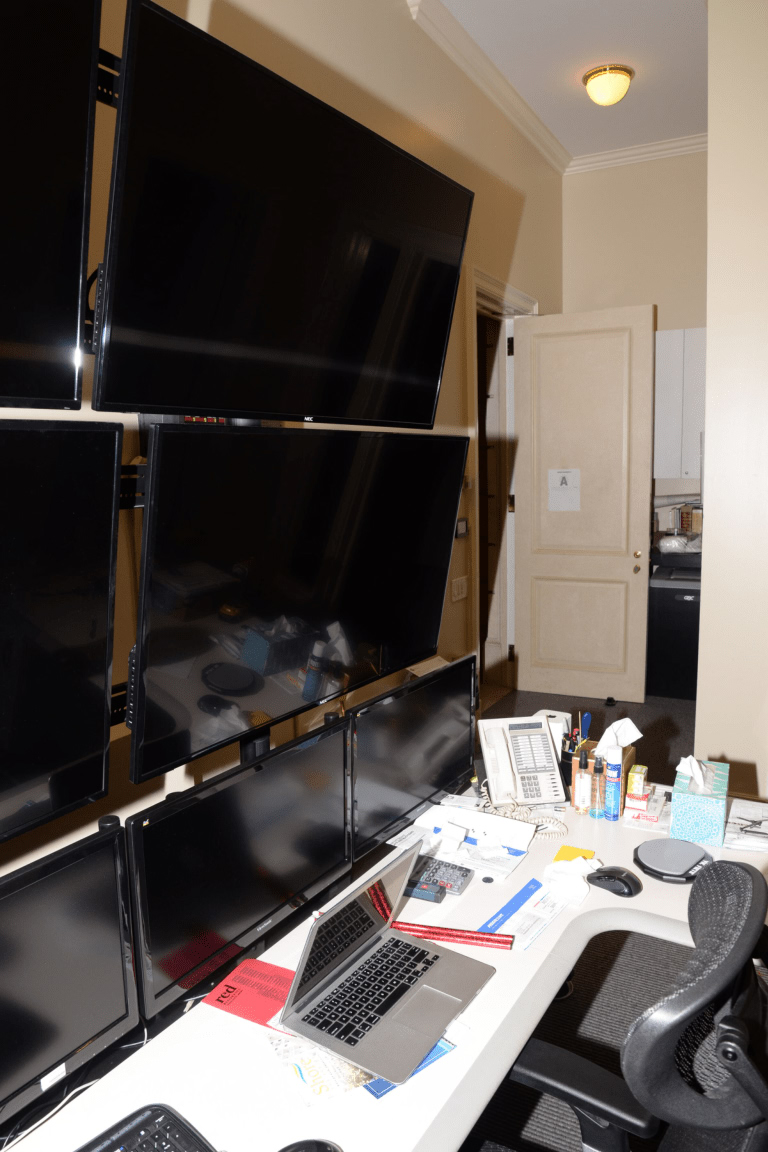 Modern office workspace with multiple monitors a laptop and a desk setup representing developer monitoring dashboards