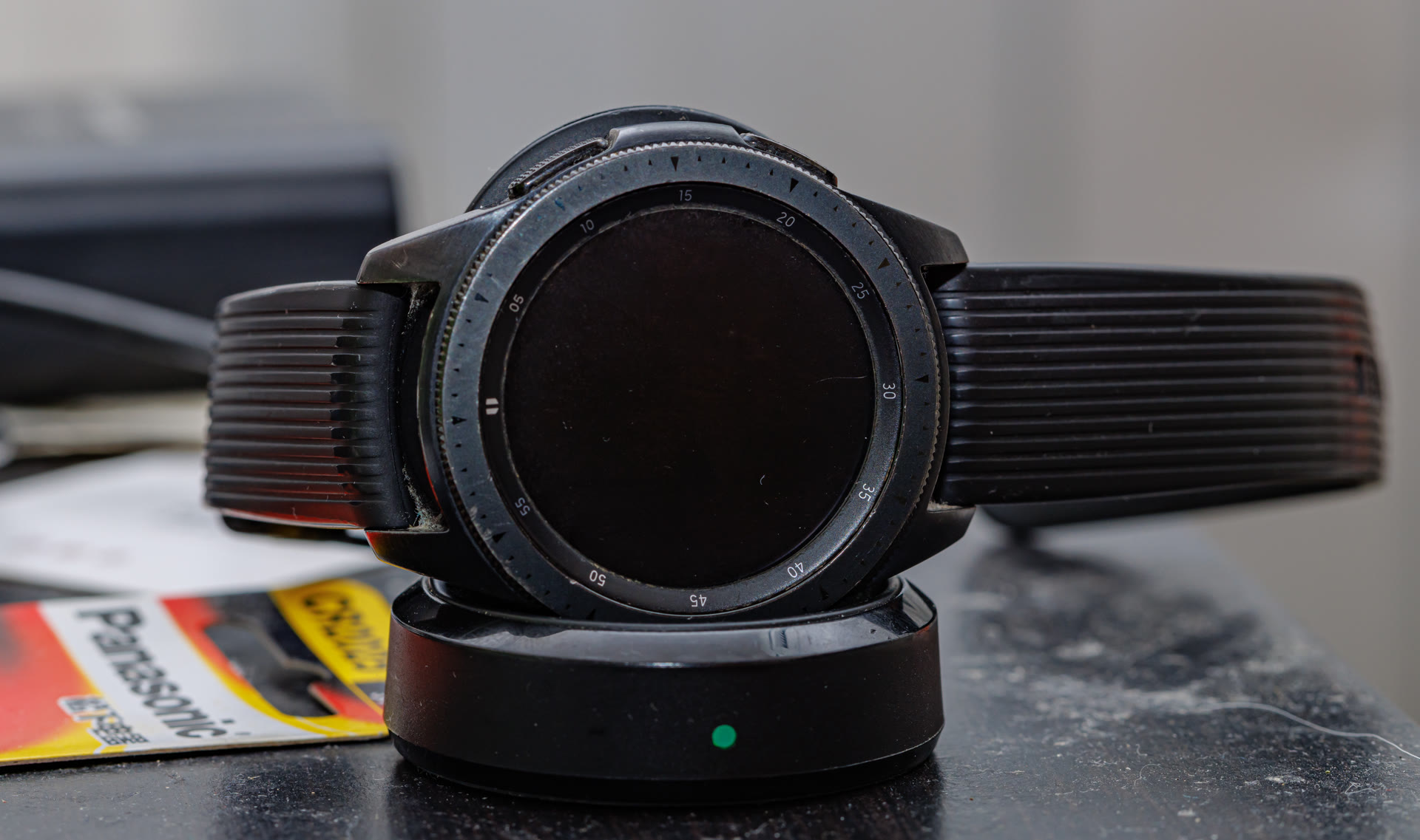 Samsung Galaxy Watch on a surface showing fitness tracking features