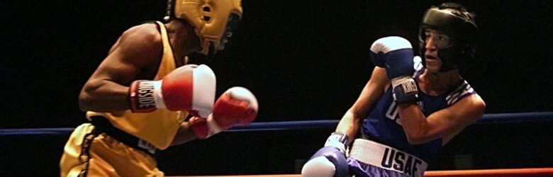 Two boxers square off in a boxing ring during an Armed Forces Boxing Competition