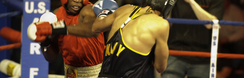 Two boxers punching mid-bout in a boxing ring