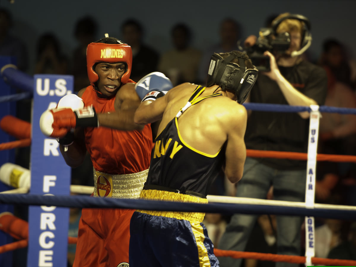 Two boxers punching mid-bout in a boxing ring