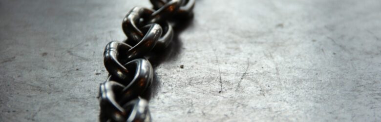 Close-up of metal chain links, illustrating the mold linker joining object files