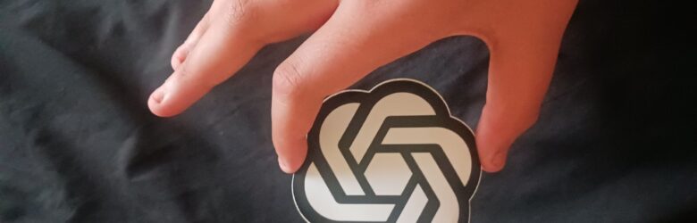Person holding OpenAI icon