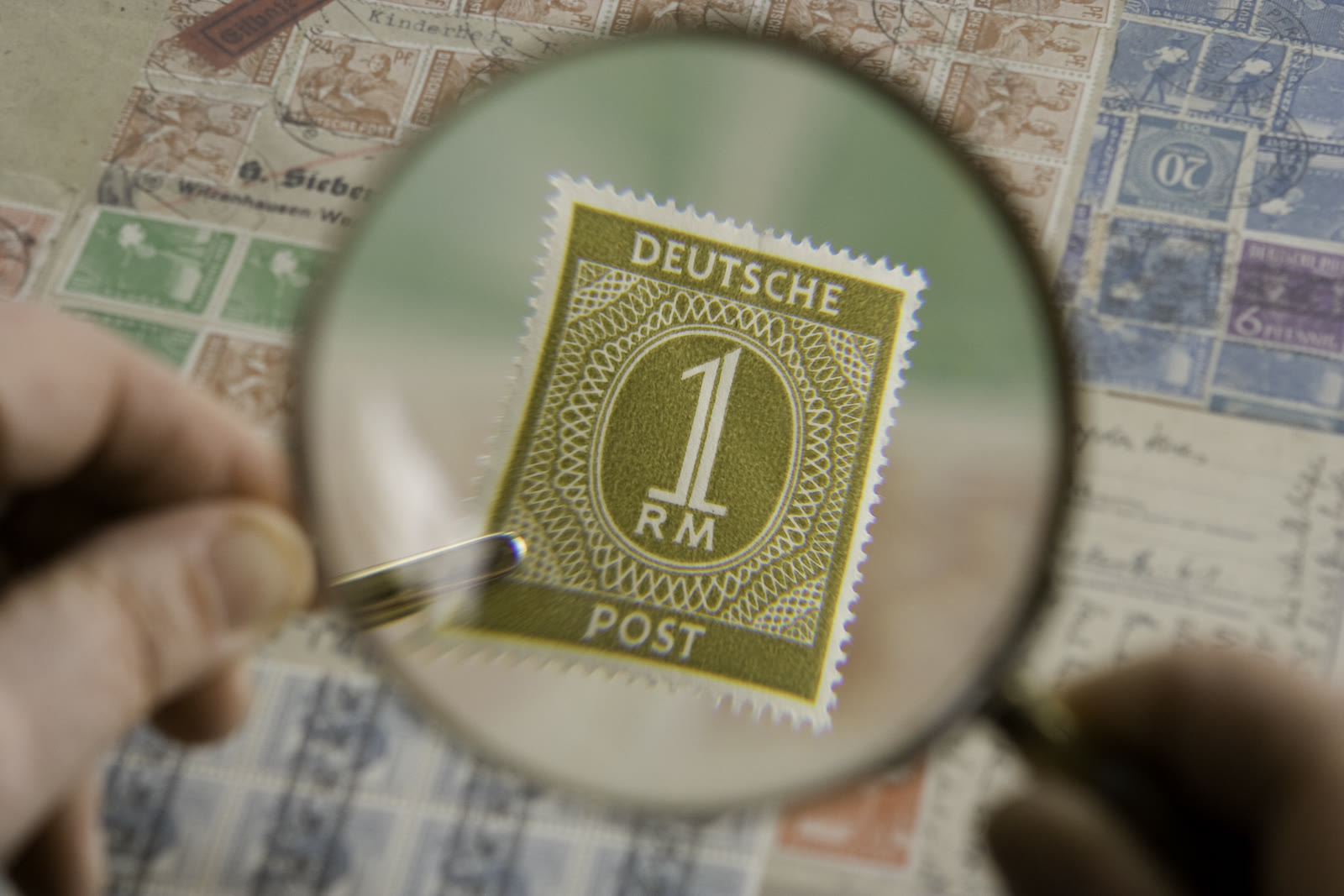 Magnifying glass inspecting text, representing AI watermark detection