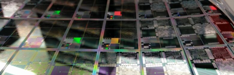 Close-up of a semiconductor wafer with microchip dies, illustrating AI inference chip hardware