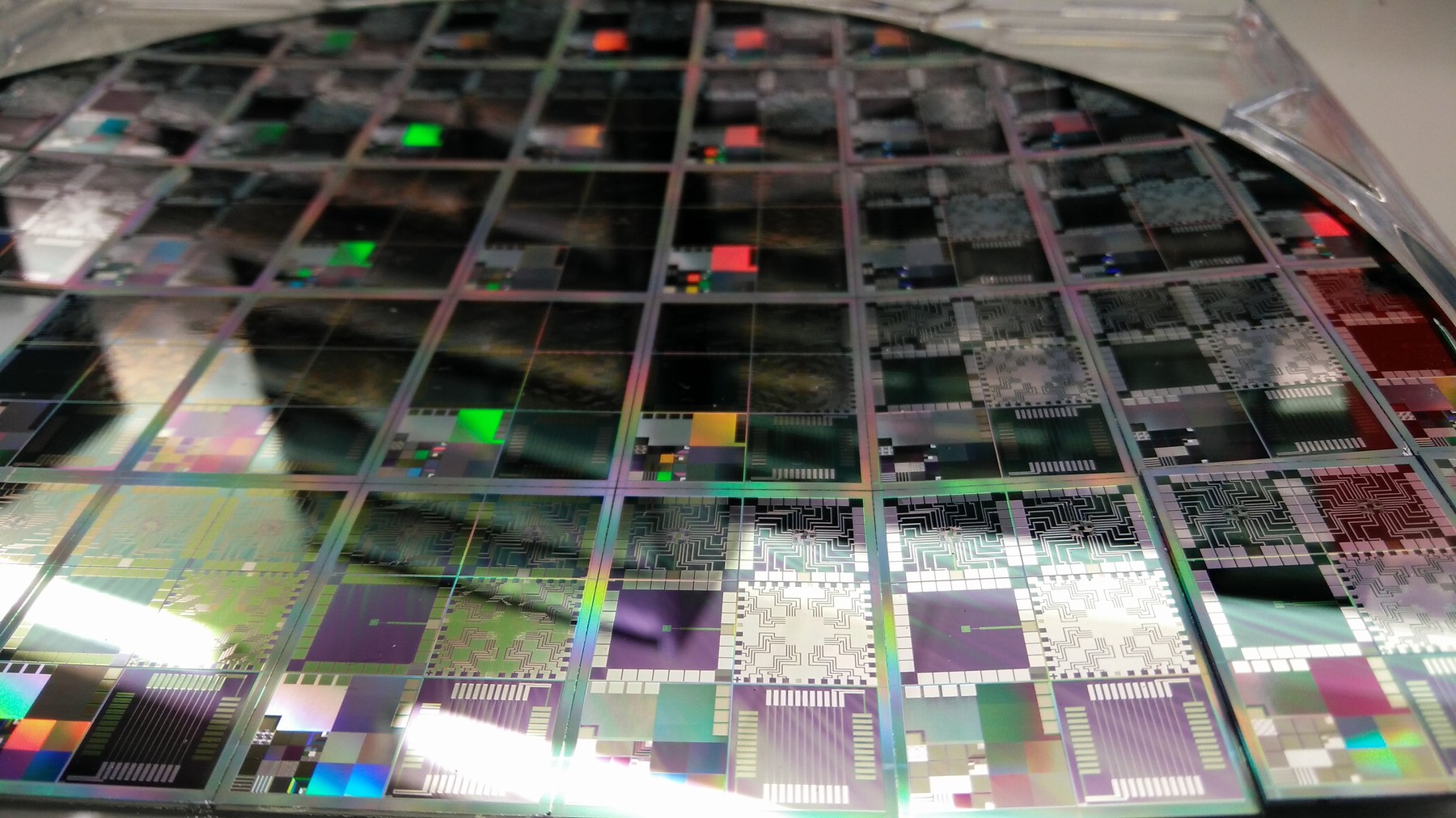 Close-up of a semiconductor wafer with microchip dies, illustrating AI inference chip hardware