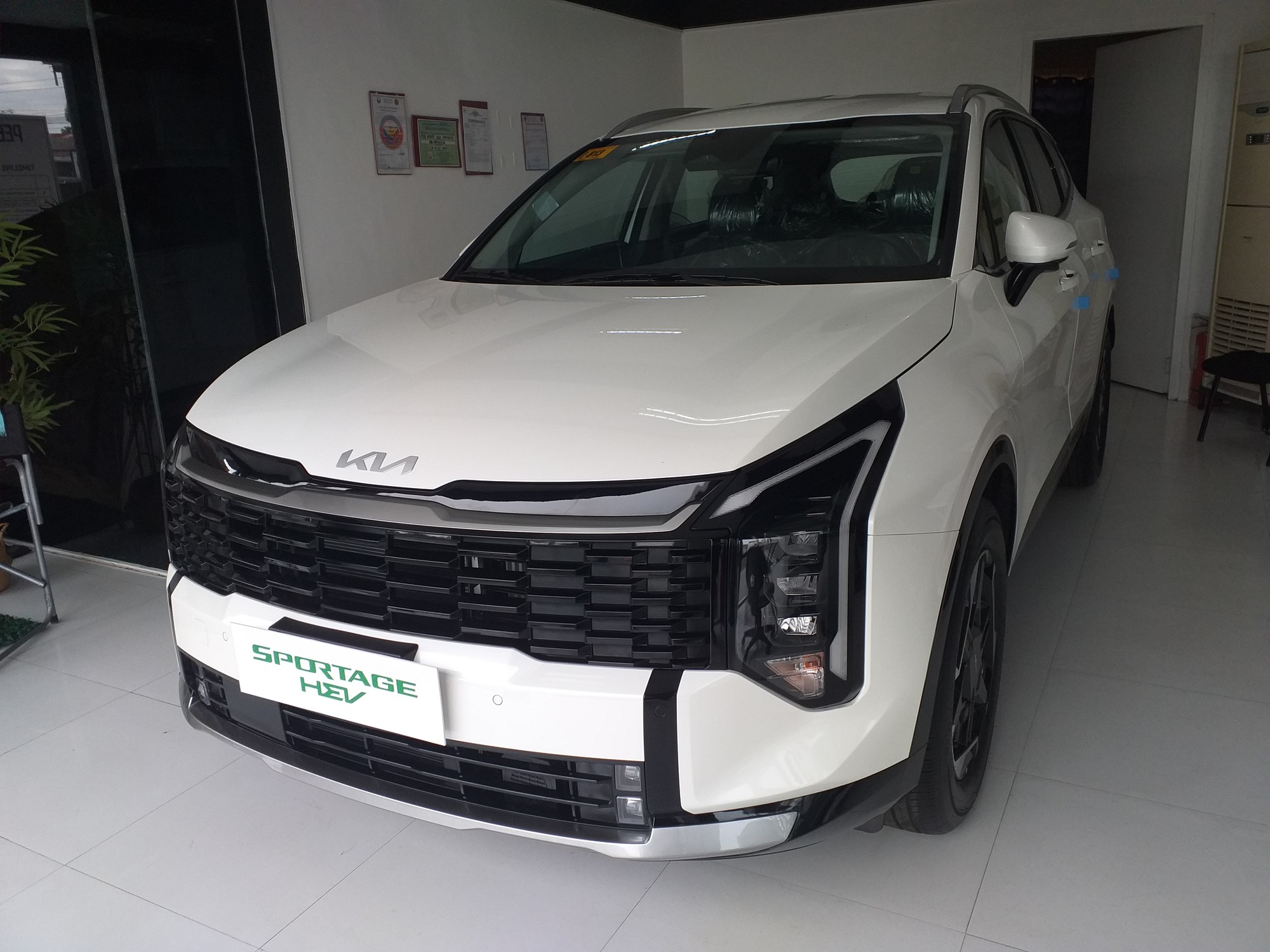 Fifth-generation Kia Sportage Turbo Hybrid crossover in white