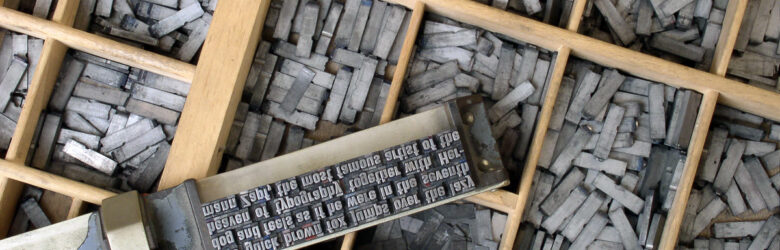 Close-up of metal movable type letters on a letterpress case, illustrating typography and the CSS ch character-width unit