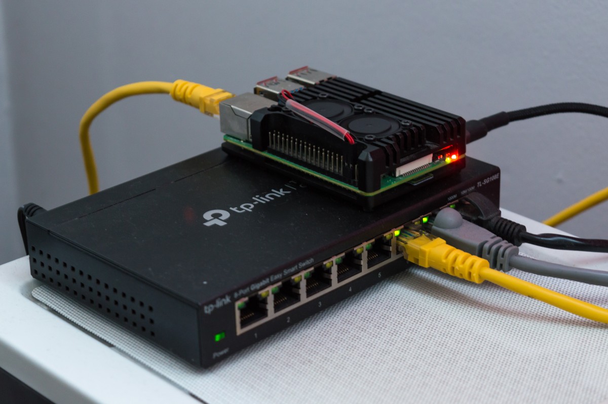 Raspberry Pi 4 sitting on a rackmount network switch, representing a local AI model router