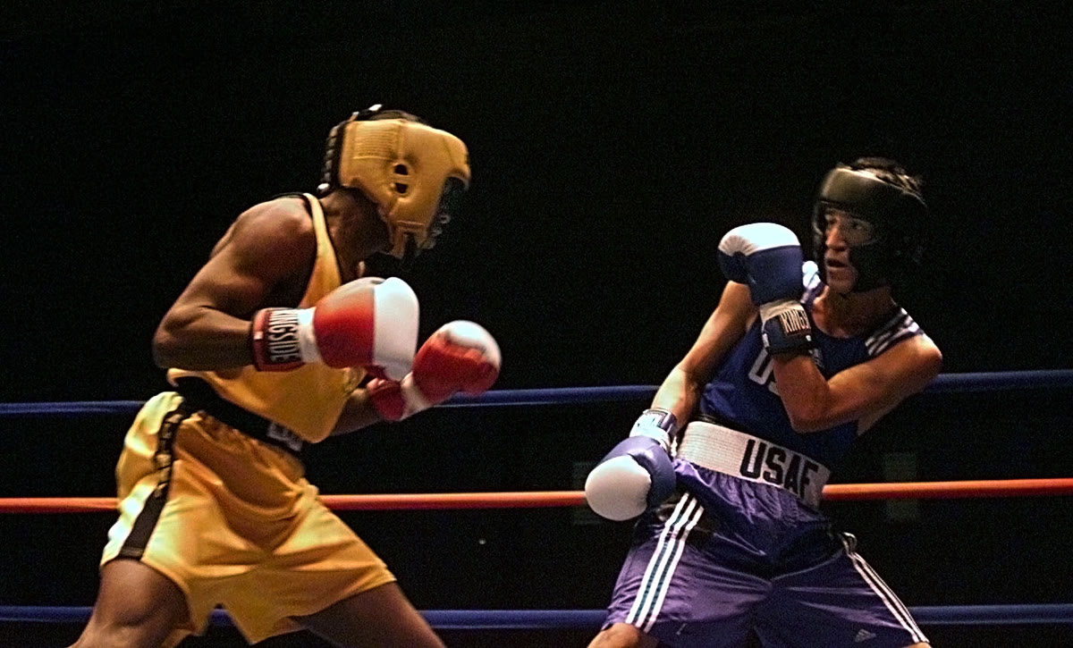 Two heavyweight boxers trade punches in the ring during a title fight