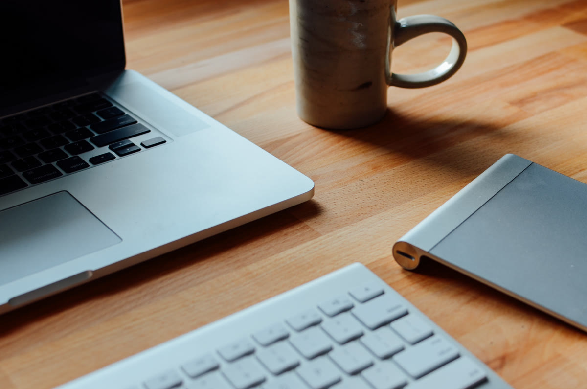 Developer workspace featuring a laptop and coffee mug on a desk