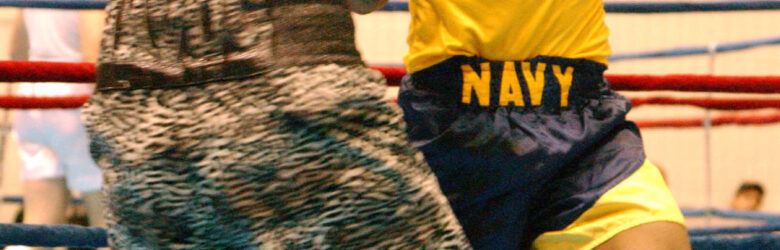 Two U.S. Navy boxers in the ring during a championship fight at the National Boxing Tournament