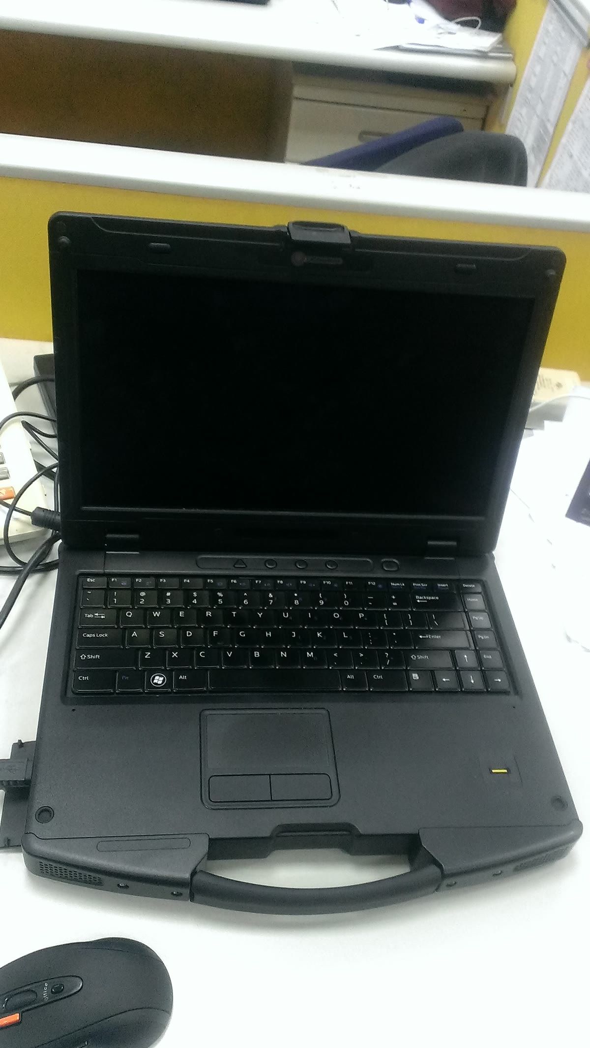 A rugged laptop computer displayed on a stand